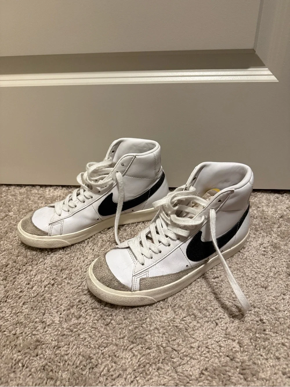 Nike White High-Top Sneakers with Black Swoosh